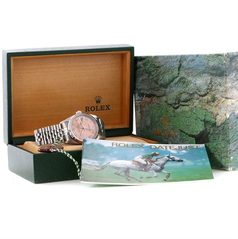The Rolex Datejust 16234 Men
s Stainless Steel Pink Dial 16234 Men
s Stainless Steel Pink Dial watch is displayed in its box, along with the brand
s booklet and protective case.
