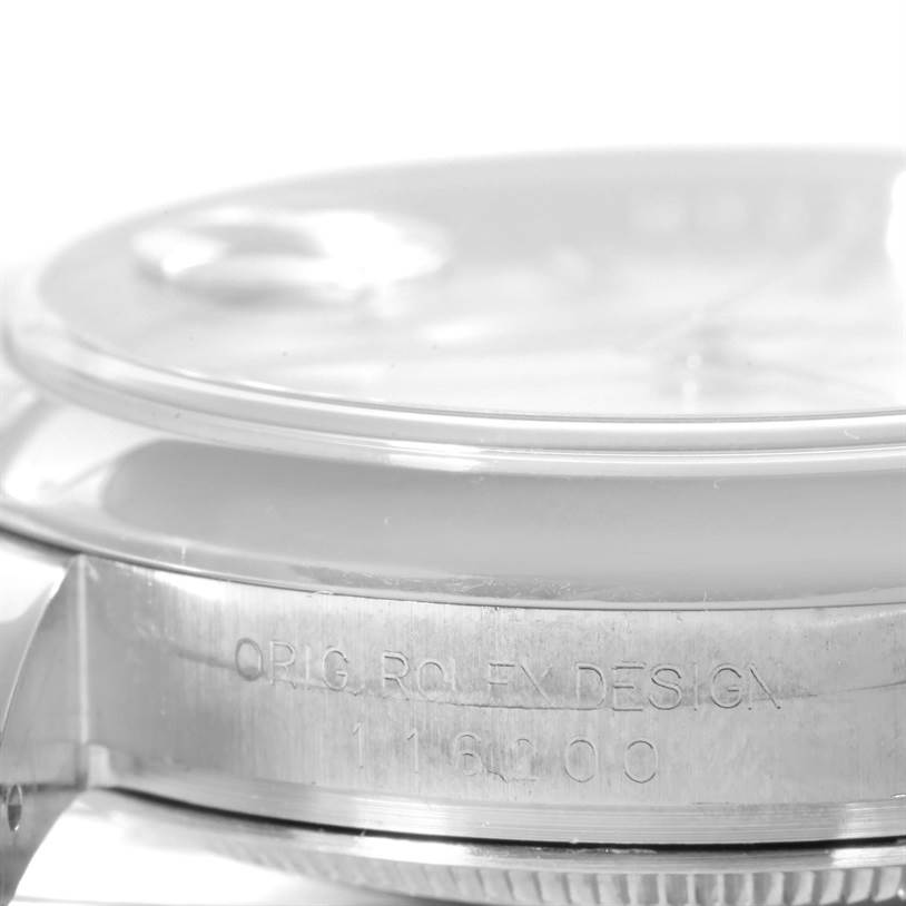 The image shows a close-up side view of the Rolex Datejust 116200 Men's Stainless Steel Silver Dial 116200 Men's Stainless Steel Silver Dial model, highlighting the case and model number engraving.
