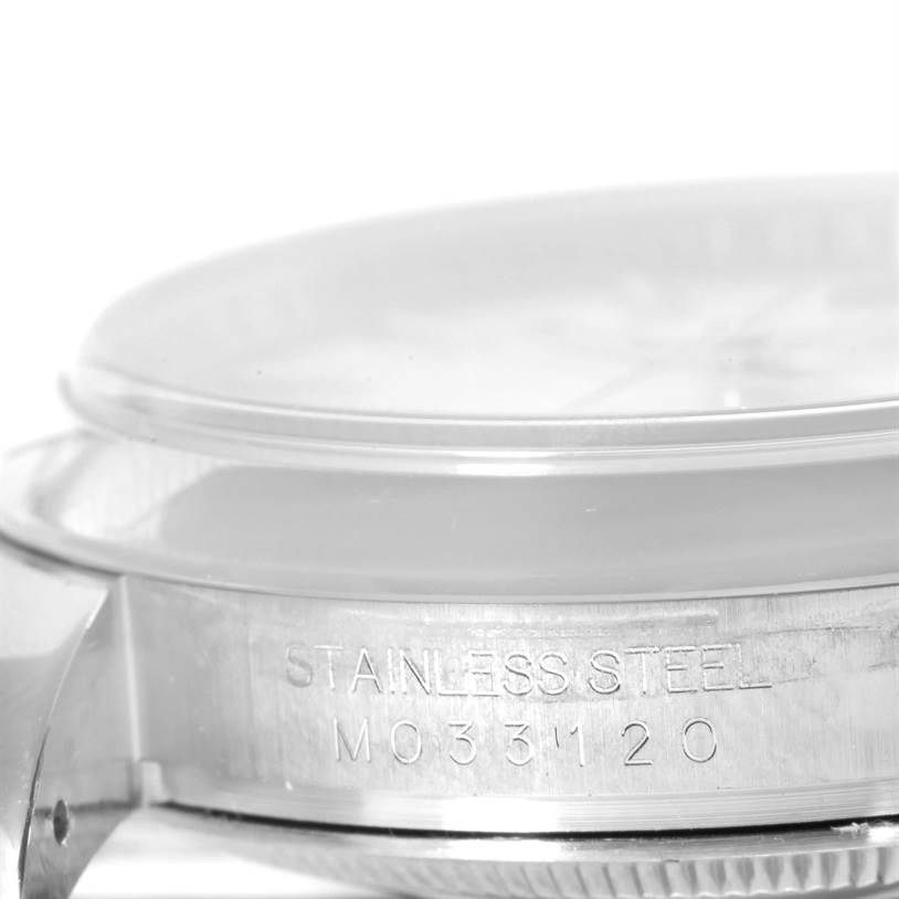 This image shows a close-up angle of the case and side details of a Rolex Datejust 116200 Men's Stainless Steel Silver Dial 116200 Men's Stainless Steel Silver Dial, focusing on the serial number.