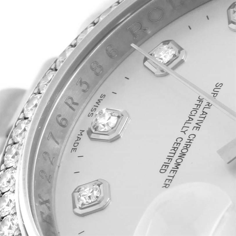 This close-up of a Rolex Datejust 116244 Men's Stainless Steel Silver Dial 116244 Men's Stainless Steel Silver Dial watch shows the diamond hour markers, bezel, and partially visible text on the dial.