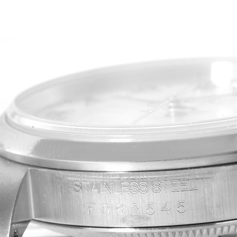 This image shows a close-up of the side of a Rolex Datejust 16200 Men's Stainless Steel White Dial 16200 Men's Stainless Steel White Dial watch case, focusing on the stainless steel and serial number.