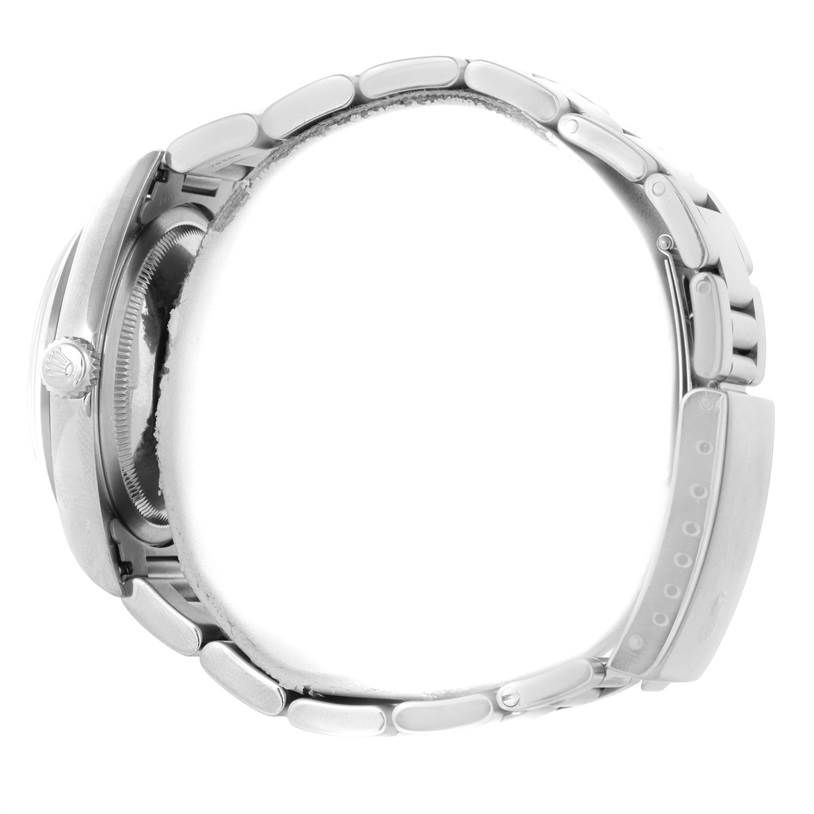 This side view of the Rolex Datejust 16200 Men's Stainless Steel White Dial 16200 Men's Stainless Steel White Dial watch shows a partial bracelet and the crown.