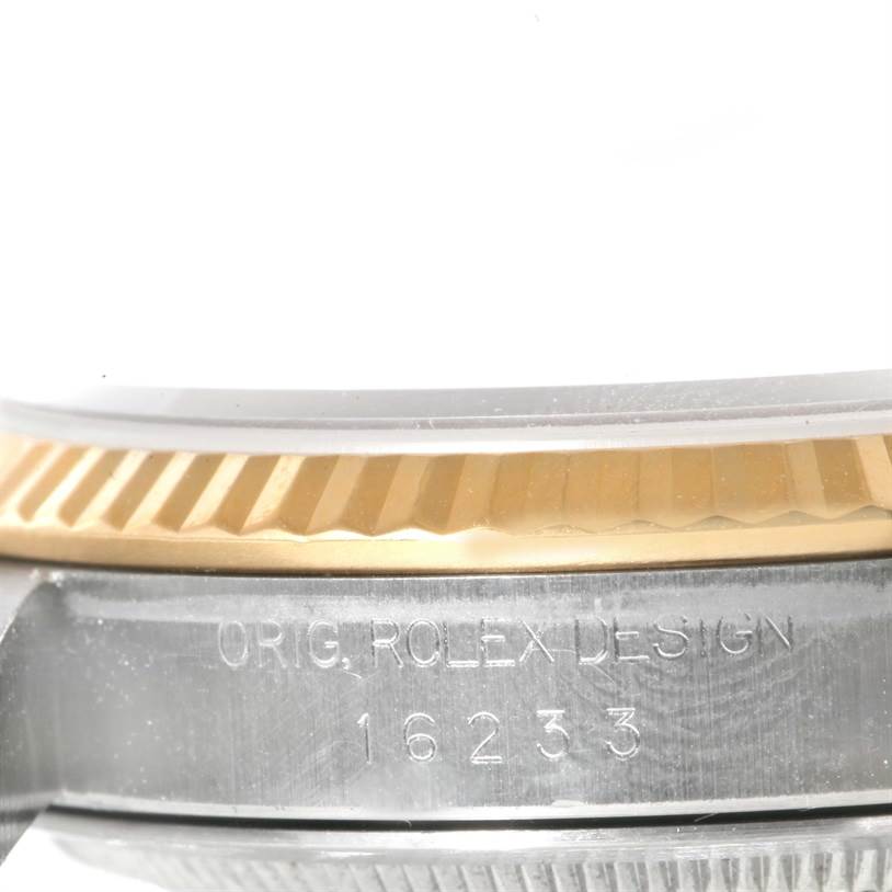 The image shows a close-up of the side of the case, bezel, and model number of a Rolex Datejust 16233 Men's Steel and Gold (two tone) White Dial 16233 Men's Steel and Gold (two tone) White Dial watch.