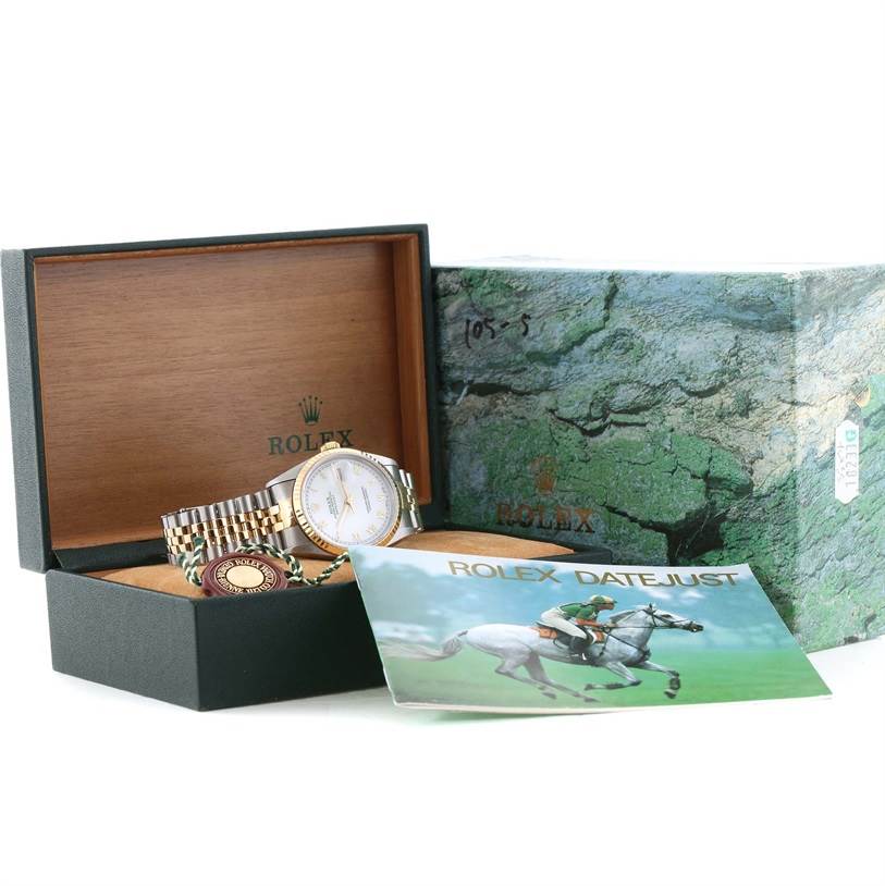 The Rolex Datejust 16233 Men's Steel and Gold (two tone) White Dial 16233 Men's Steel and Gold (two tone) White Dial watch is shown at an angle inside its open box, along with its accessories and a brochure.