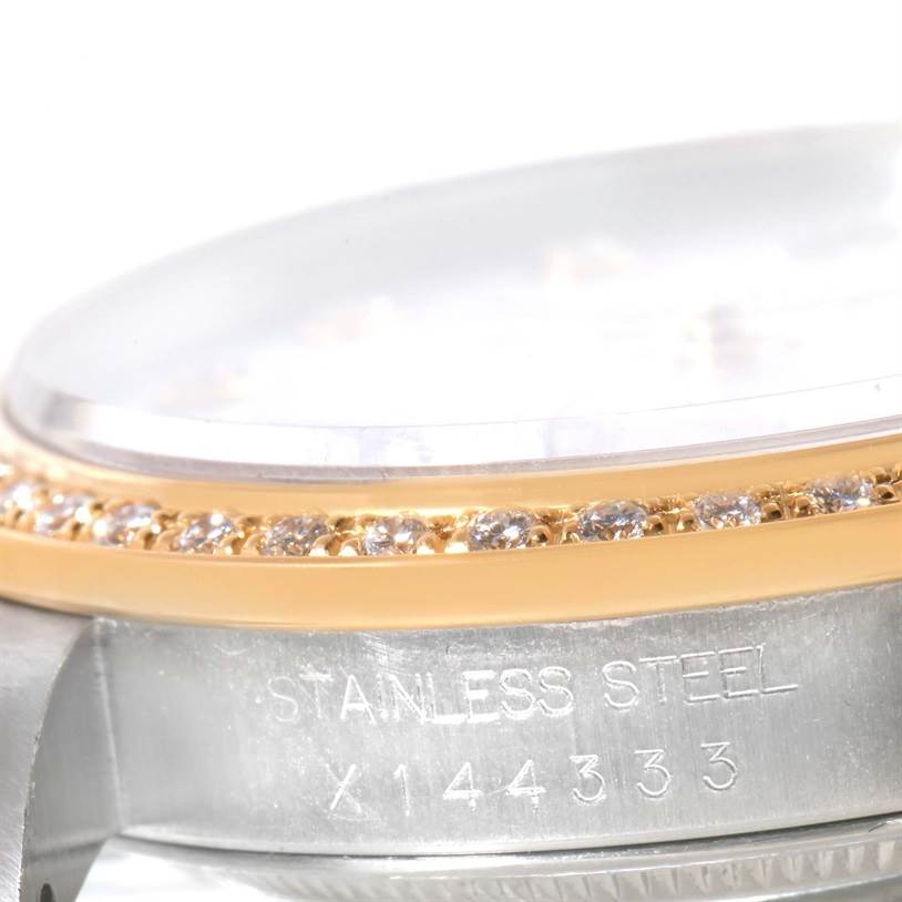 The image shows a close-up side view of the Rolex Datejust 16233 Men
s Steel and Gold (two tone) Mother of Pearl Dial 16233 Men
s Steel and Gold (two tone) Mother of Pearl Dial watch, highlighting its bezel with diamonds and part of the case.