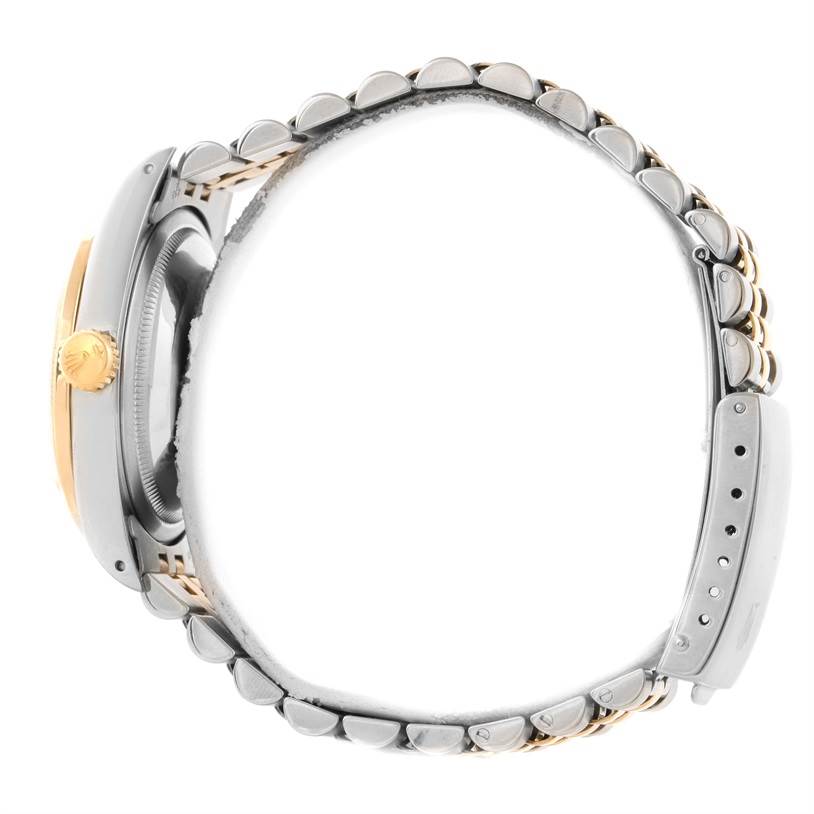 The Rolex Datejust 16233 Men
s Steel and Gold (two tone) Mother of Pearl Dial 16233 Men
s Steel and Gold (two tone) Mother of Pearl Dial watch is shown from a side profile, highlighting the crown, case, and part of the bracelet.