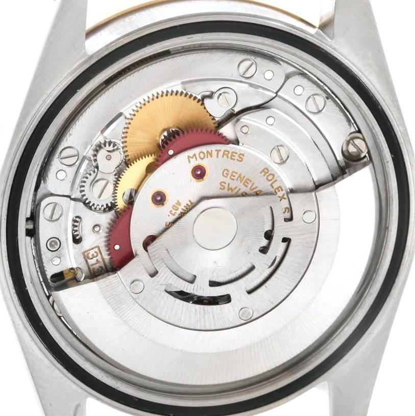This image shows the internal mechanism of a Rolex Datejust 16233 Men
s Steel and Gold (two tone) Mother of Pearl Dial 16233 Men
s Steel and Gold (two tone) Mother of Pearl Dial watch, focusing on the intricate gears and rotor from the back.