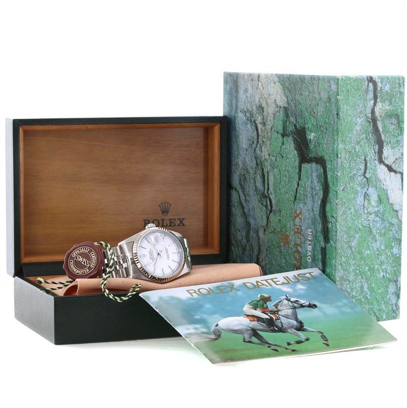 The image shows a Rolex Datejust 16234 Men
s Stainless Steel White Dial 16234 Men
s Stainless Steel White Dial watch, its original wooden box, an Best Quality
ity tag, and the instruction manual.