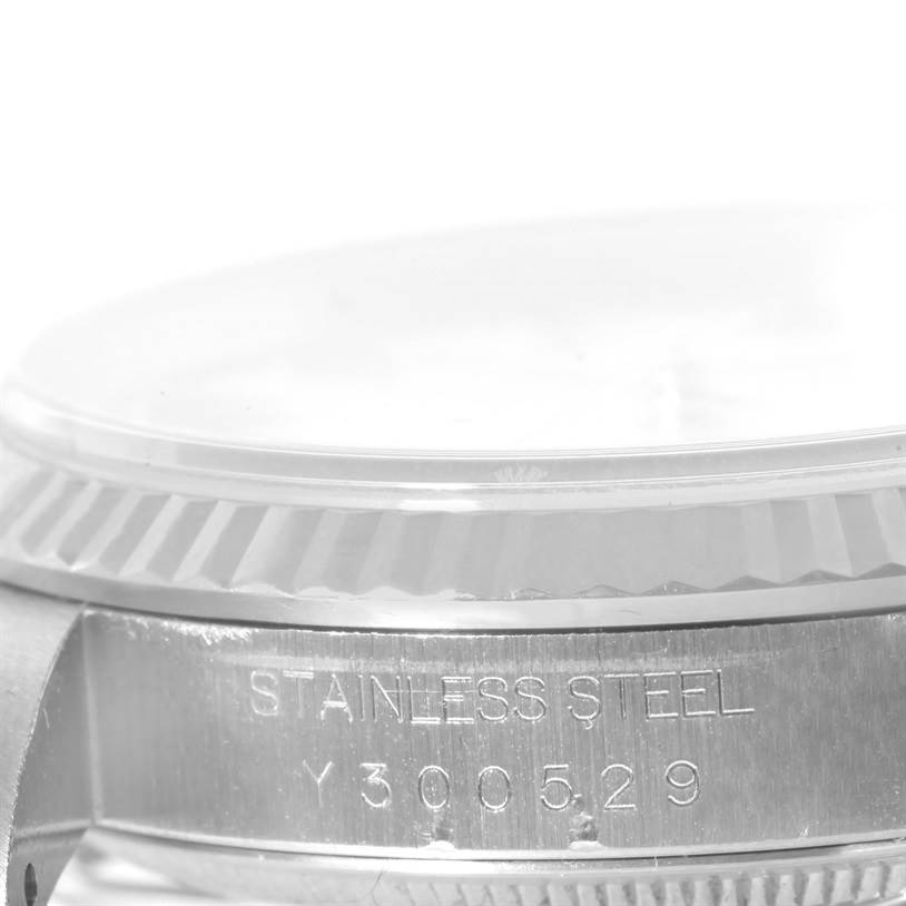This image shows the side view of a Rolex Datejust 16234 Men
s Stainless Steel White Dial 16234 Men
s Stainless Steel White Dial watch, highlighting the engraving "STAINLESS STEEL" and a serial number on the case.