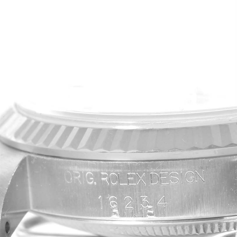 The image shows a close-up of the side of a Rolex Datejust 16234 Men
s Stainless Steel White Dial 16234 Men
s Stainless Steel White Dial watch case, focusing on the serial number and bezel.
