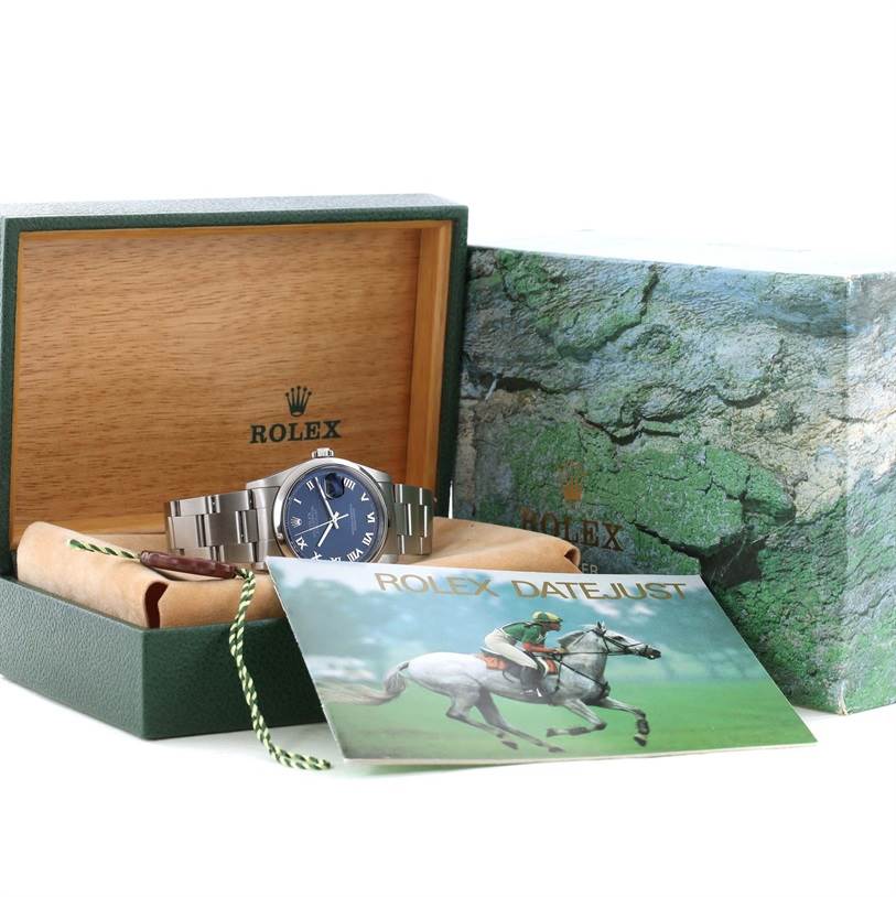 The image shows a Rolex Datejust 16200 Men's Stainless Steel Blue Dial 16200 Men's Stainless Steel Blue Dial watch displayed in an open box with its accessories and booklet.