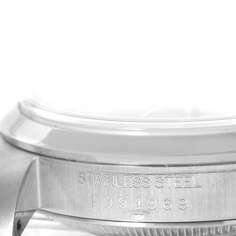 The image shows a close-up side view of the stainless steel case and serial number of a Rolex Datejust 16200 Men's Stainless Steel Blue Dial 16200 Men's Stainless Steel Blue Dial model watch.