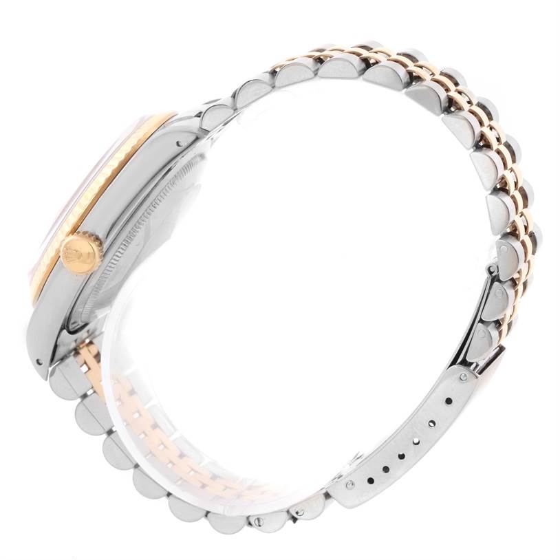 This image shows a Rolex Datejust 16233 Men's Steel and Gold (two tone) Champagne Dial 16233 Men's Steel and Gold (two tone) Champagne Dial watch from a side angle, highlighting its crown, case, and two-tone bracelet.