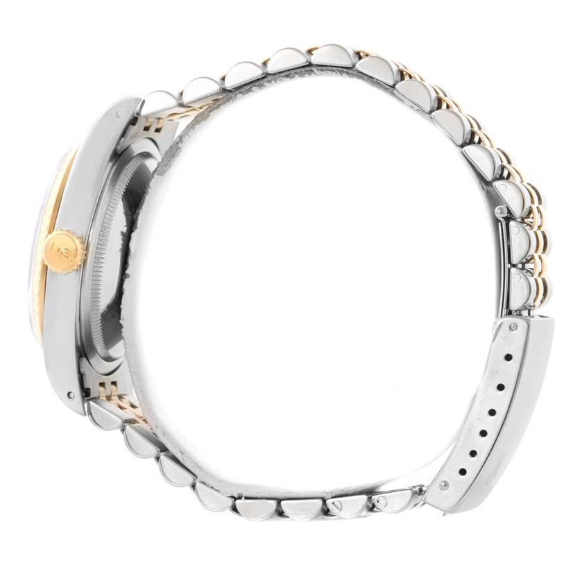 This image shows a side view of the Rolex Datejust 16233 Men's Steel and Gold (two tone) Black Dial 16233 Men's Steel and Gold (two tone) Black Dial watch, highlighting its case, crown, and metal bracelet.