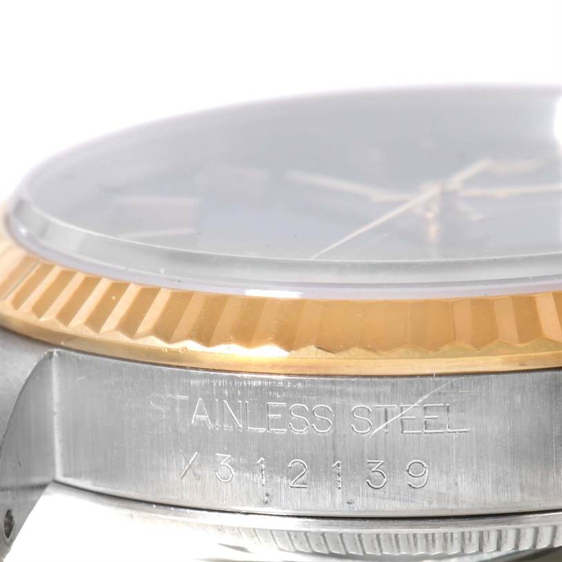This image shows a close-up side view of the bezel and case of the Rolex Datejust 16233 Men's Steel and Gold (two tone) Black Dial 16233 Men's Steel and Gold (two tone) Black Dial, highlighting its stainless steel and gold details.