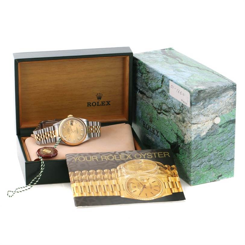 The image shows a Rolex Datejust 16233 Men's Steel and Gold (two tone) Champagne Dial 16233 Men's Steel and Gold (two tone) Champagne Dial watch, packaging box, and accompanying booklet, photographed from a slightly elevated front angle.