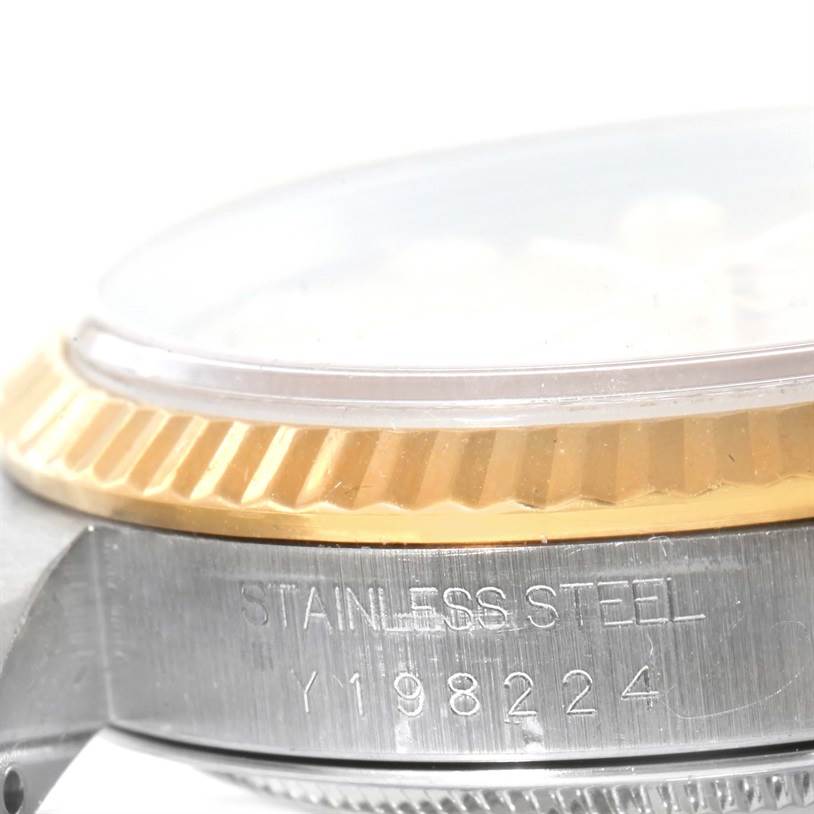 The image shows a close-up of the side of a Rolex Datejust 16233 Men's Steel and Gold (two tone) Champagne Dial 16233 Men's Steel and Gold (two tone) Champagne Dial watch, highlighting the stainless steel casing and engraved model number.