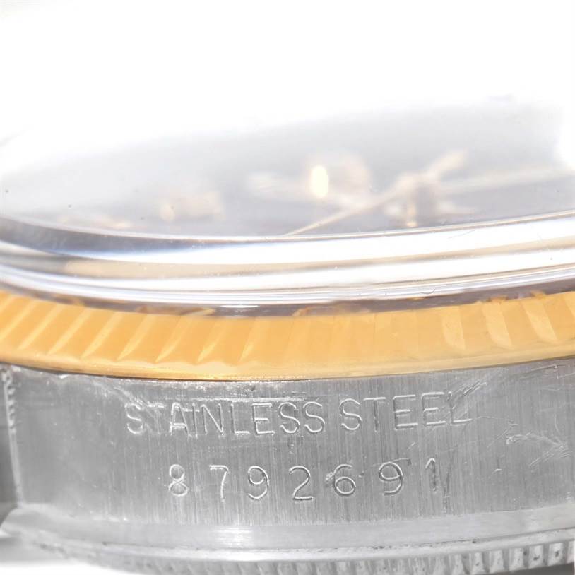 This image shows a close-up of the side of a Rolex Datejust 16013 Men
s Stainless Steel Black Dial 16013 Men
s Stainless Steel Black Dial watch, focusing on the serial number and "STAINLESS STEEL" engraving.
