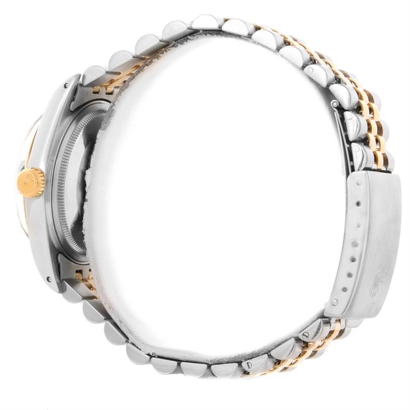 This image shows the side view of the Rolex Datejust 16013 Men
s Stainless Steel Black Dial 16013 Men
s Stainless Steel Black Dial
s band, crown, clasp, and partially the case back.