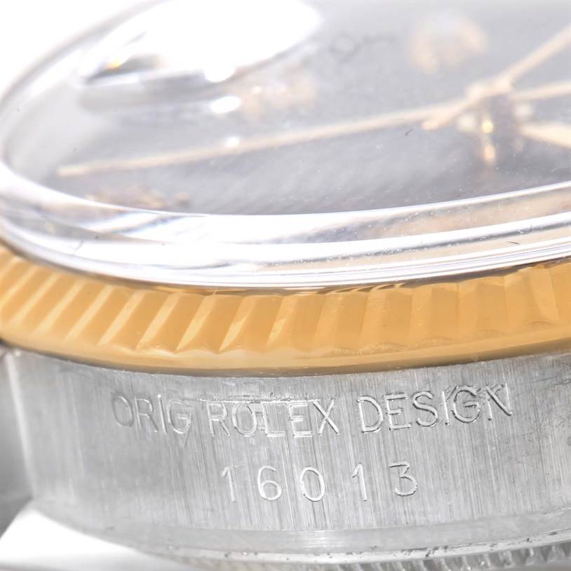 This close-up angle shows the side of the Rolex Datejust 16013 Men
s Stainless Steel Black Dial 16013 Men
s Stainless Steel Black Dial watch, including the fluted bezel, crystal, and part of the case with the engravings.