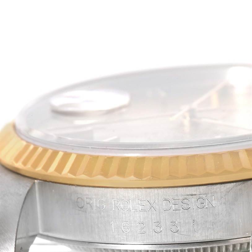 This image shows a close-up view of the bezel and part of the case of the Rolex Datejust 16233 Men's Steel and Gold (two tone) Champagne Dial 16233 Men's Steel and Gold (two tone) Champagne Dial watch, detailing its design and model number.