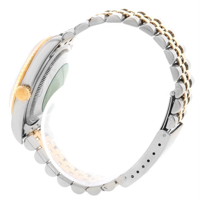 This side view of the Rolex Datejust 16233 Men's Steel and Gold (two tone) Champagne Dial 16233 Men's Steel and Gold (two tone) Champagne Dial watch focuses on the crown, case, and two-tone bracelet.