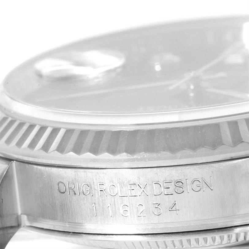 The image shows a detailed side view of the bezel and part of the case of a Rolex Datejust 116234BKDO Men's Stainless Steel Silver Dial 116234BKDO Men's Stainless Steel Silver Dial watch, including the model number engraving.