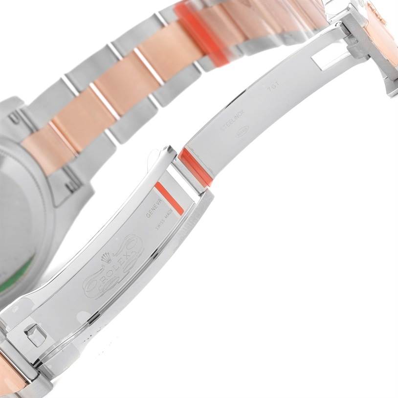 The image shows a partial side view of the clasp and bracelet of a Rolex Datejust 116201PKRO Men's Steel and Gold (two tone) Pink Dial 116201PKRO Men's Steel and Gold (two tone) Pink Dial watch, highlighting the two-tone metal and Rolex engraving.