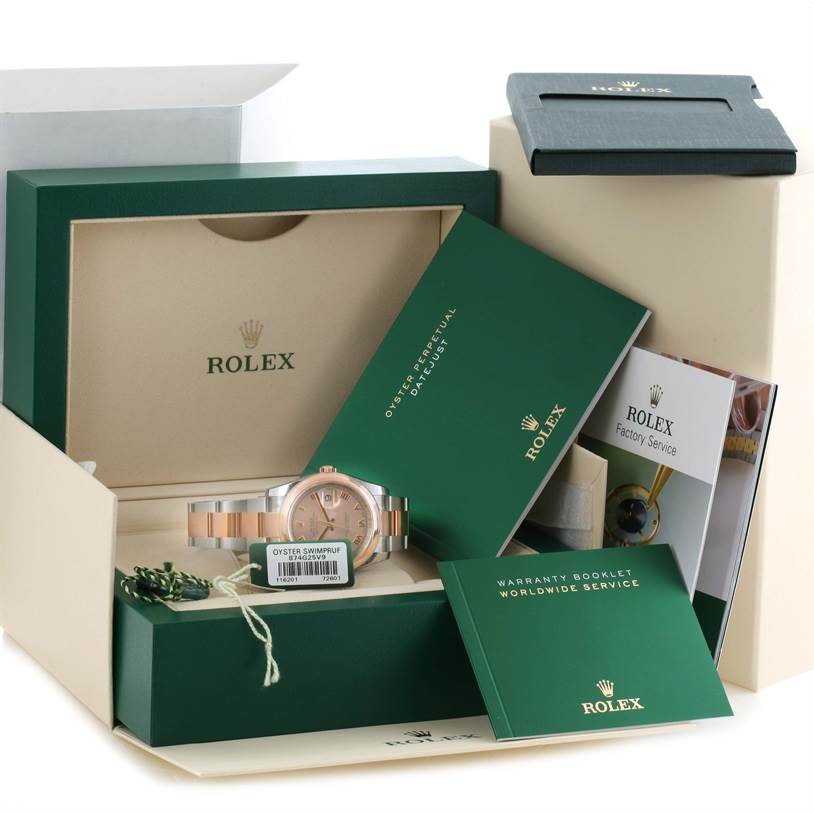 The Rolex Datejust 116201PKRO Men's Steel and Gold (two tone) Pink Dial 116201PKRO Men's Steel and Gold (two tone) Pink Dial watch is shown with its box, warranty booklet, manuals, and hang tag accessories.