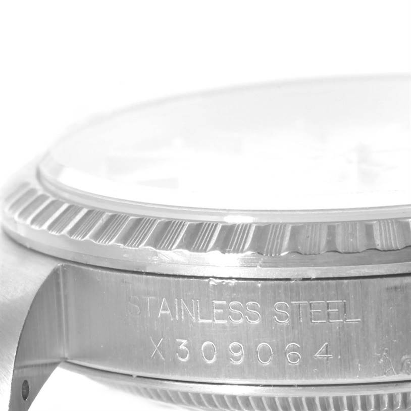 The image shows a close-up, side angle of the stainless steel bezel and case of a Rolex Datejust 16220 Men's Stainless Steel Silver Dial 16220 Men's Stainless Steel Silver Dial watch.