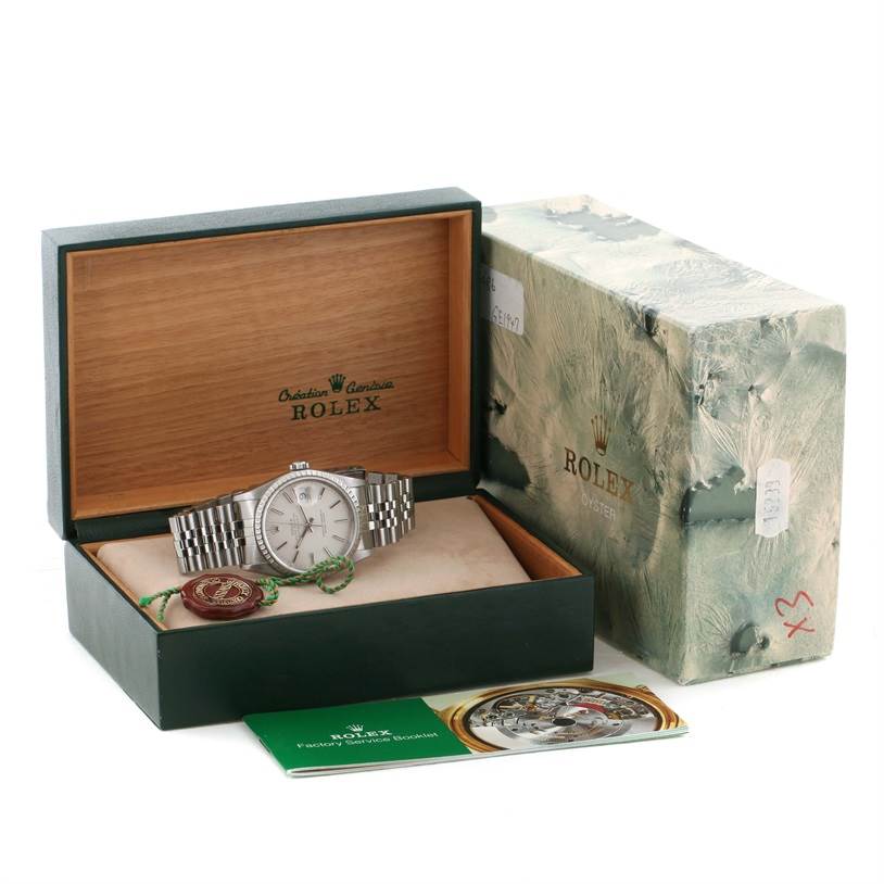 The Rolex Datejust 16220 Men's Stainless Steel Silver Dial 16220 Men's Stainless Steel Silver Dial watch is shown inside its open box, along with the outer box and accompanying booklet.