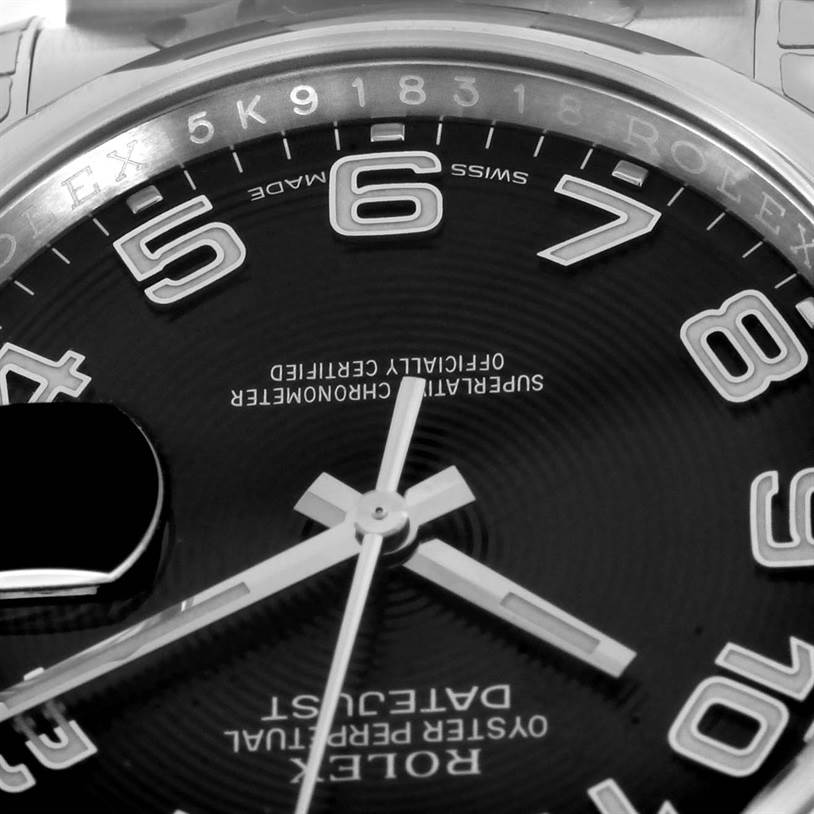 This is a close-up of the dial and part of the bezel of a Rolex Datejust 116200BKAO Men
s Stainless Steel Black Dial 116200BKAO Men
s Stainless Steel Black Dial watch, displaying the numerals and hands.