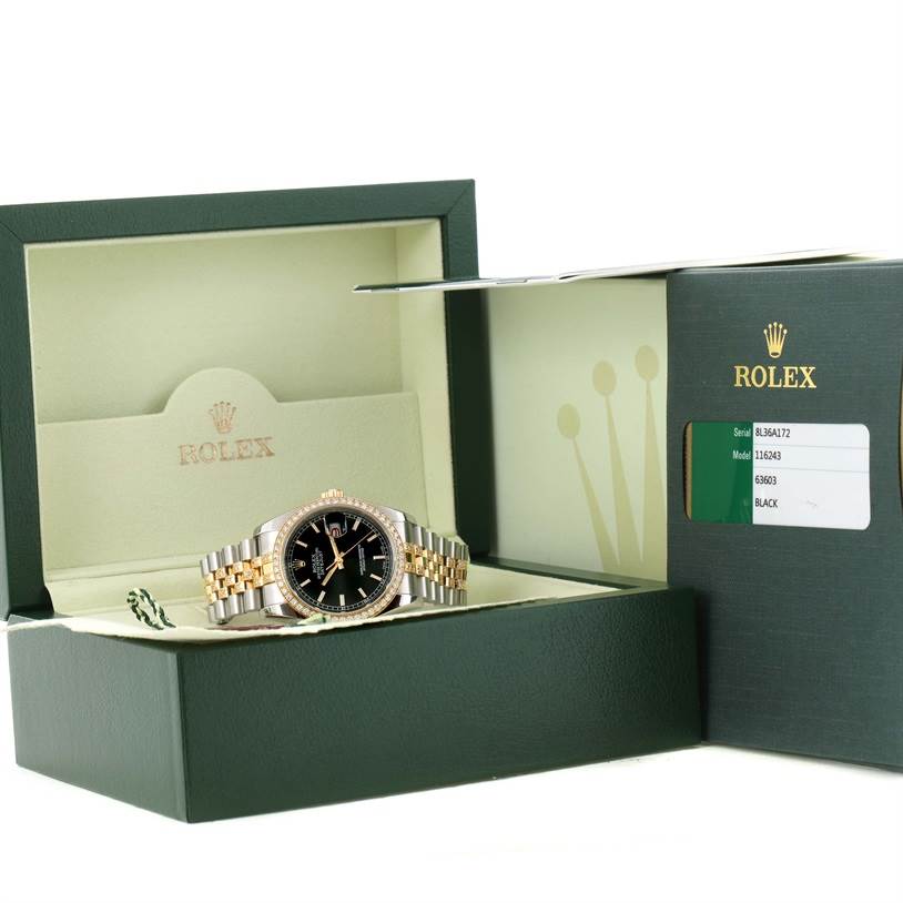 The image shows a Rolex Datejust 116243 Men
s Stainless Steel Black Dial 116243 Men
s Stainless Steel Black Dial watch at an oblique angle in an open box, with a warranty card beside it.