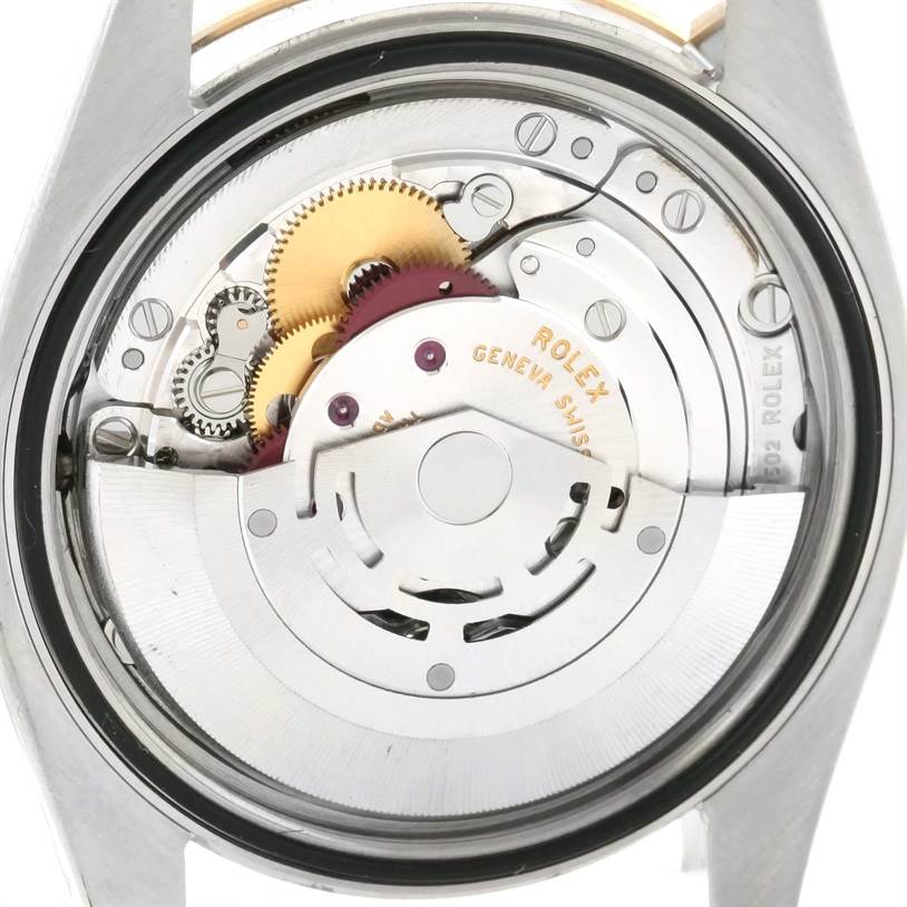 The image shows the back view of the internal mechanism of a Rolex Datejust 116243 Men
s Stainless Steel Black Dial 116243 Men
s Stainless Steel Black Dial watch, including gears and the rotor.