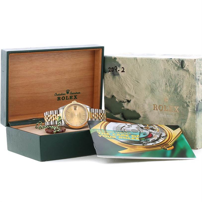 The image shows a Rolex Datejust 16233 Men's Steel and Gold (two tone) Champagne Dial 16233 Men's Steel and Gold (two tone) Champagne Dial watch in its open box with papers and tags, plus an outer box.