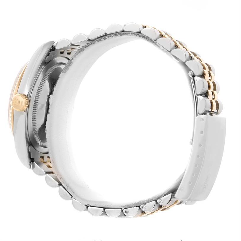 This is a side view of a Rolex Datejust 16233 Men's Steel and Gold (two tone) Champagne Dial 16233 Men's Steel and Gold (two tone) Champagne Dial watch showing its crown, case, and part of the bracelet.