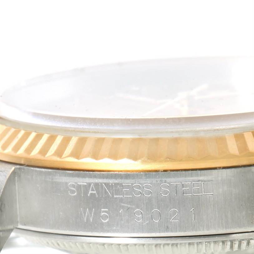 This close-up image shows the side view of a Rolex Datejust 16233 Men's Steel and Gold (two tone) Champagne Dial 16233 Men's Steel and Gold (two tone) Champagne Dial watch, highlighting the stainless steel case and bezel.