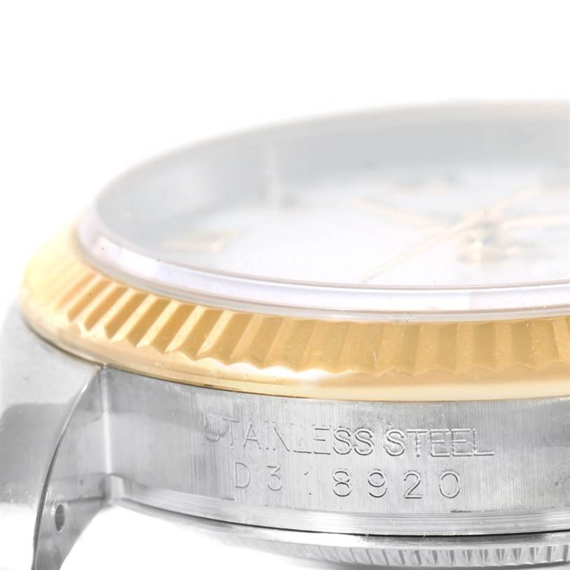 This image shows a side angle of the Rolex Datejust 116233 Men
s Stainless Steel White Dial 116233 Men
s Stainless Steel White Dial watch focusing on its bezel and part of the case with engraved serial number.