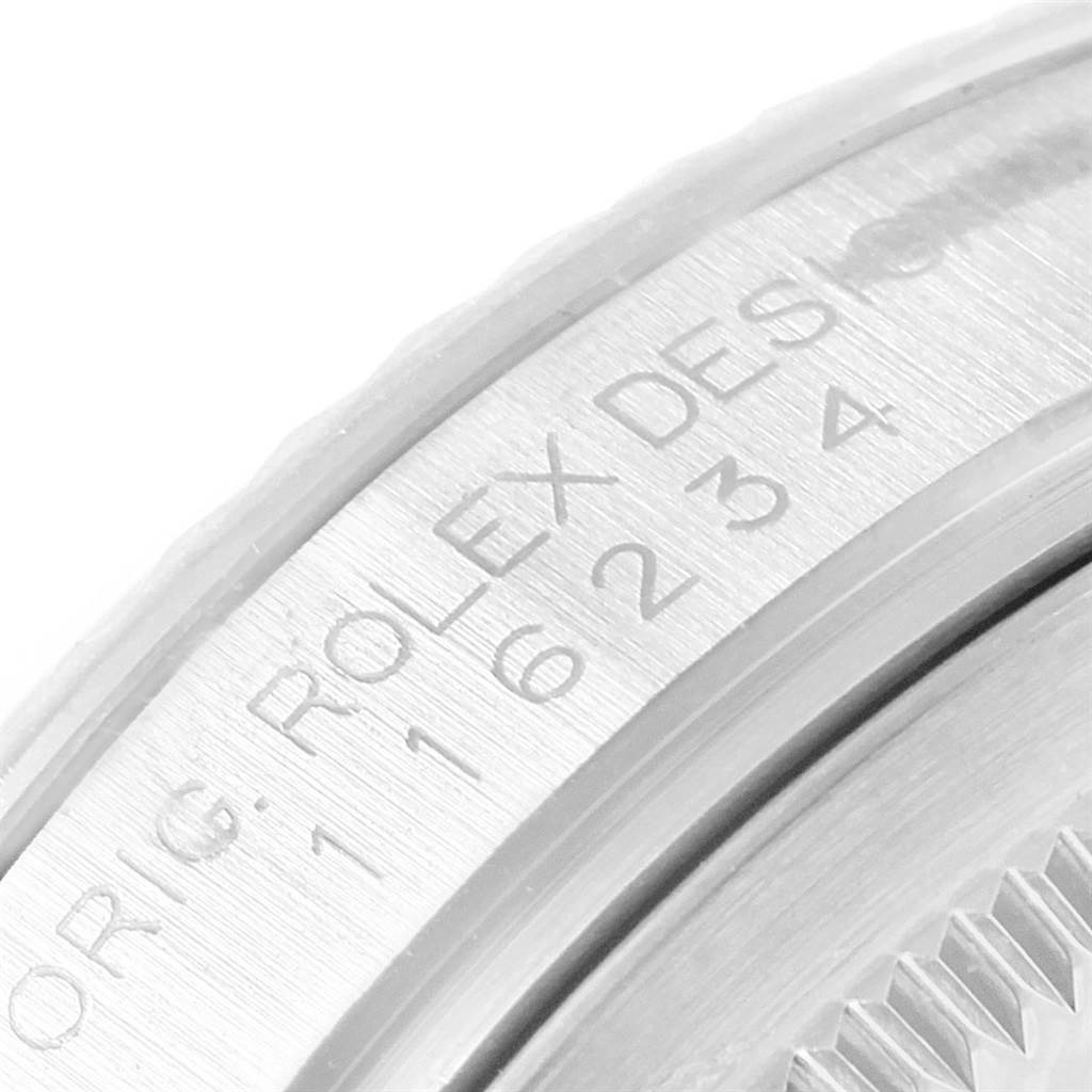 The close-up image shows the engraved details on the case back of a Rolex Datejust 116234 Men's Stainless Steel Black Dial 116234 Men's Stainless Steel Black Dial watch.