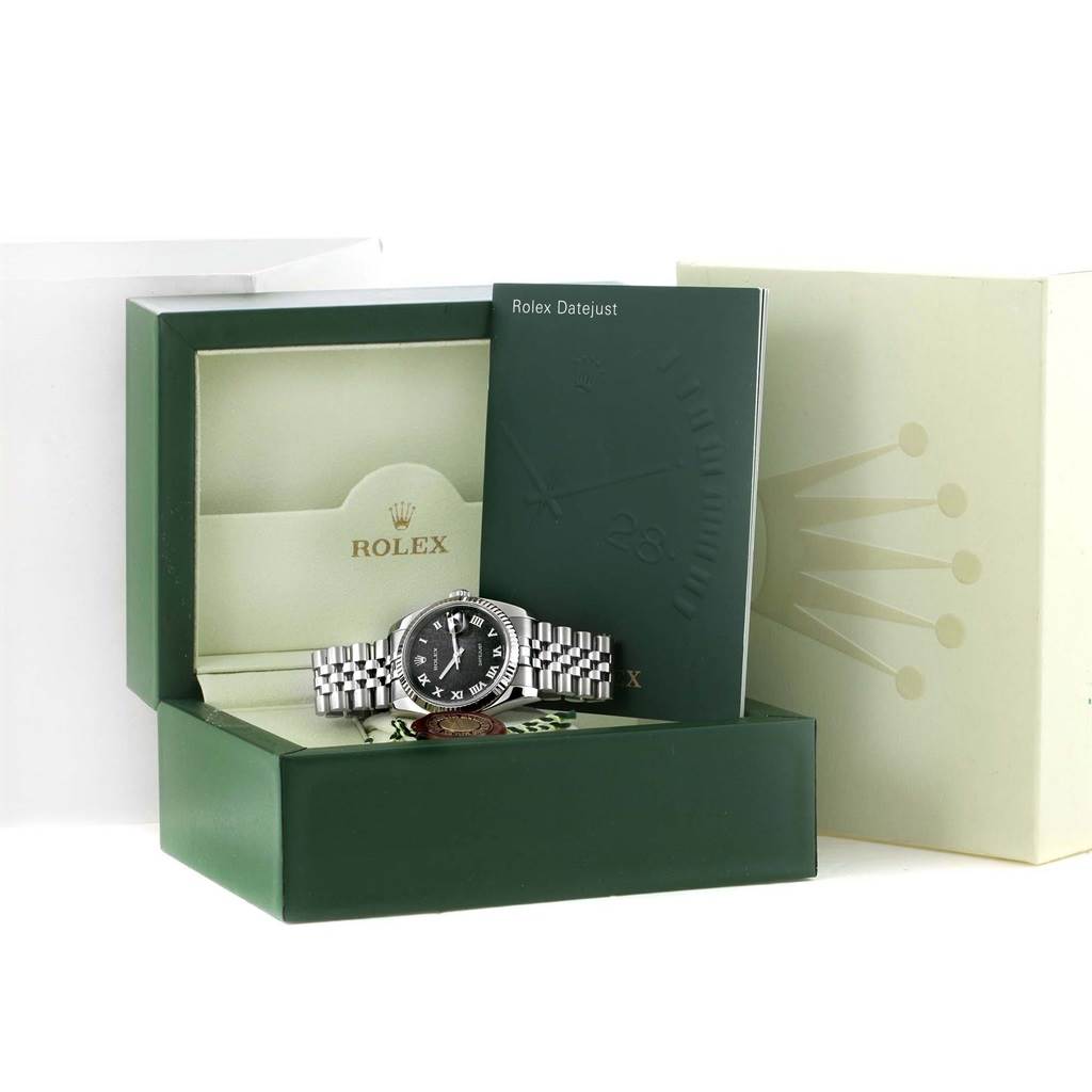 The Rolex Datejust 116234 Men's Stainless Steel Black Dial 116234 Men's Stainless Steel Black Dial watch is shown inside its green presentation box with associated booklets and packaging.