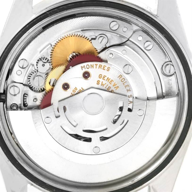 The image shows the movement mechanism of a Rolex Datejust 16233 Men's Steel and Gold (two tone) Black Dial 16233 Men's Steel and Gold (two tone) Black Dial watch viewed from the back, highlighting gears and the rotor.