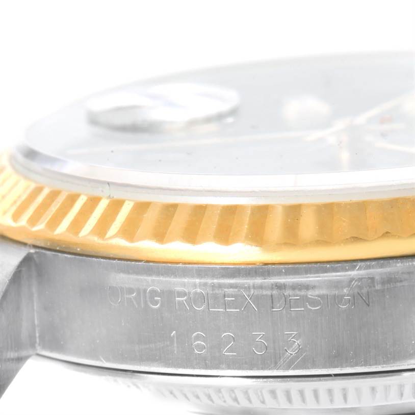 The image shows a close-up side view of a Rolex Datejust 16233 Men's Steel and Gold (two tone) Black Dial 16233 Men's Steel and Gold (two tone) Black Dial watch, highlighting the fluted bezel and part of the case with the model number.