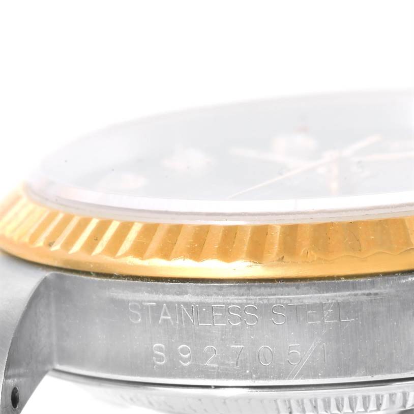 This image shows a close-up view of the side case and fluted bezel of a Rolex Datejust 16233 Men's Steel and Gold (two tone) Black Dial 16233 Men's Steel and Gold (two tone) Black Dial watch.