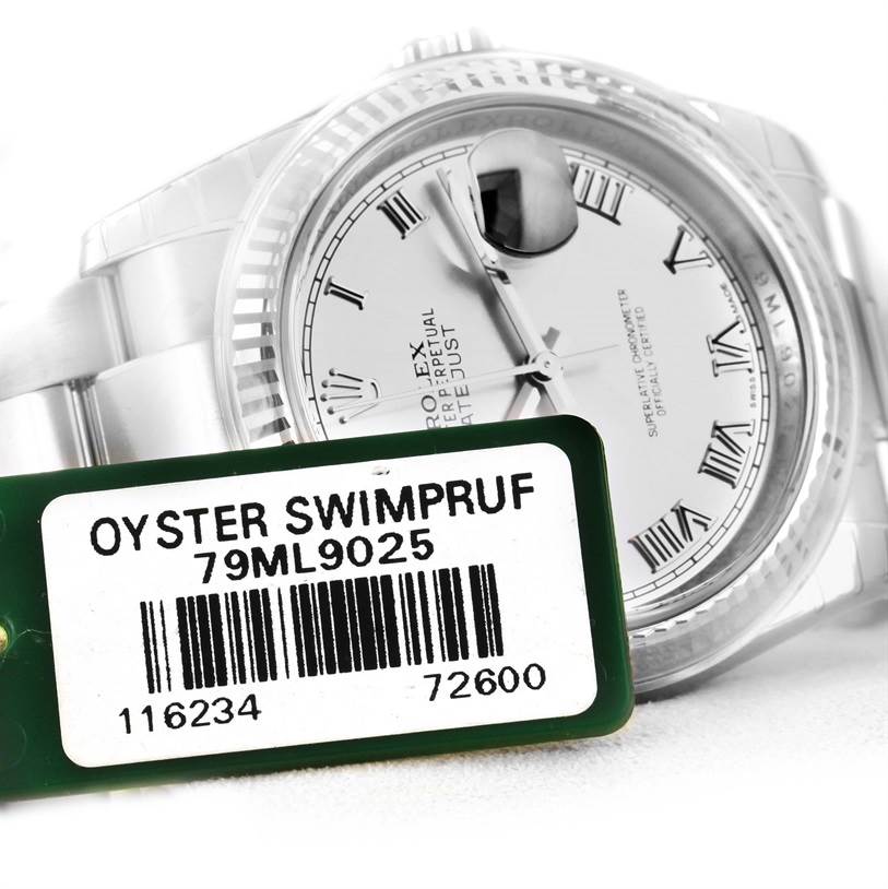 The Rolex Datejust 116234 Men
s Stainless Steel Grey Dial 116234 Men
s Stainless Steel Grey Dial watch is shown at an angle, highlighting its dial, bezel, and barcode tag.