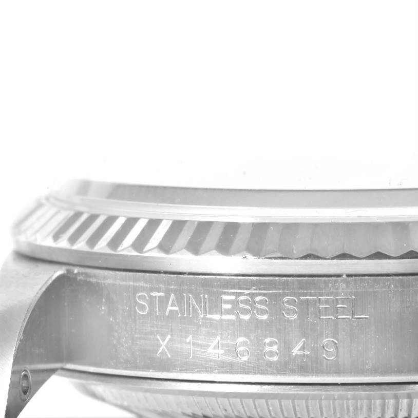 This image shows a close-up view of the bezel and case side with engravings on a Rolex Datejust 16234 Men's Stainless Steel White Dial 16234 Men's Stainless Steel White Dial watch.