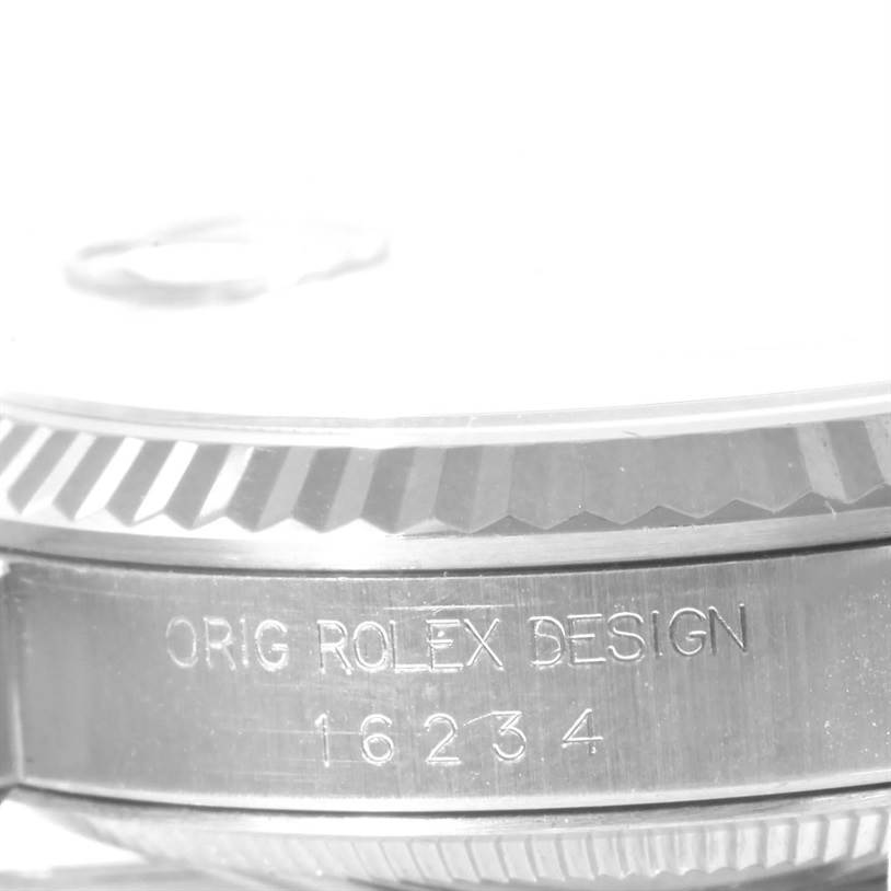 This image shows a close-up side view of a Rolex Datejust 16234 Men's Stainless Steel White Dial 16234 Men's Stainless Steel White Dial watch, highlighting the engraved bezel and case with the model number 16234.