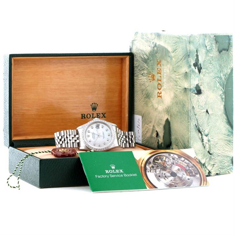 The Rolex Datejust 16234 Men
s Stainless Steel Mother of Pearl Dial 16234 Men
s Stainless Steel Mother of Pearl Dial watch is shown from the front within its open box, displaying booklets and a red seal beside it.