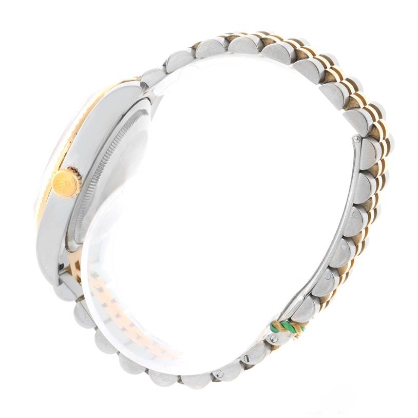 This image shows a side view of the Rolex Datejust 116233-CSJ Men
s Stainless Steel Champagne Dial 116233-CSJ Men
s Stainless Steel Champagne Dial watch, highlighting the crown and two-tone bracelet.