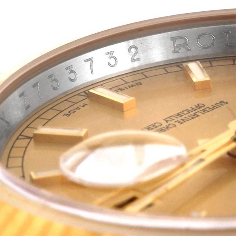 This close-up view of the Rolex Datejust 116233-CSJ Men
s Stainless Steel Champagne Dial 116233-CSJ Men
s Stainless Steel Champagne Dial watch shows the serial number and part of the dial with hour markers and text.