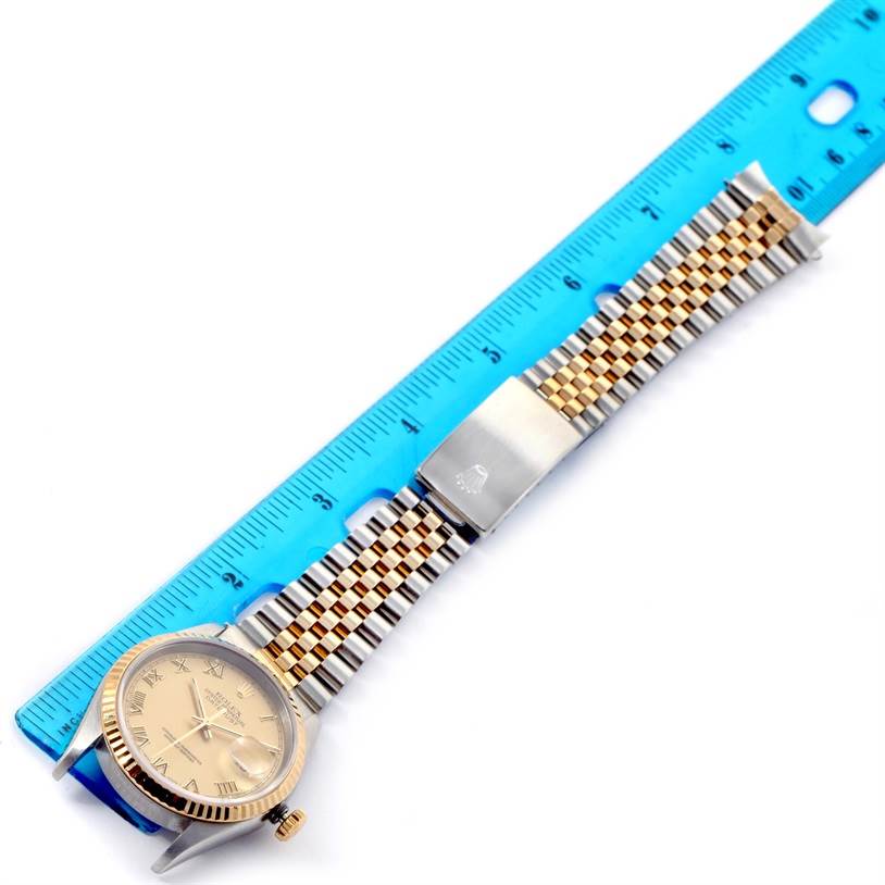 The Rolex Datejust 16233 Men
s Steel and Gold (two tone) Champagne Dial 16233 Men
s Steel and Gold (two tone) Champagne Dial watch is shown from an overhead angle, featuring the dial, bezel, crown, and Jubilee bracelet.